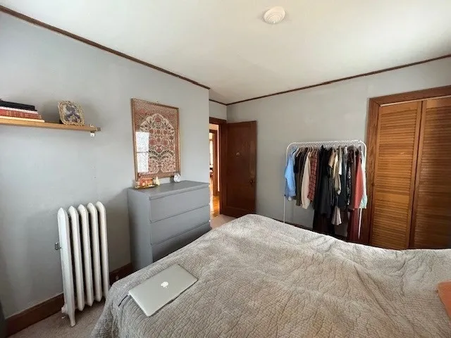 a bedroom with a bed and a walk in closet