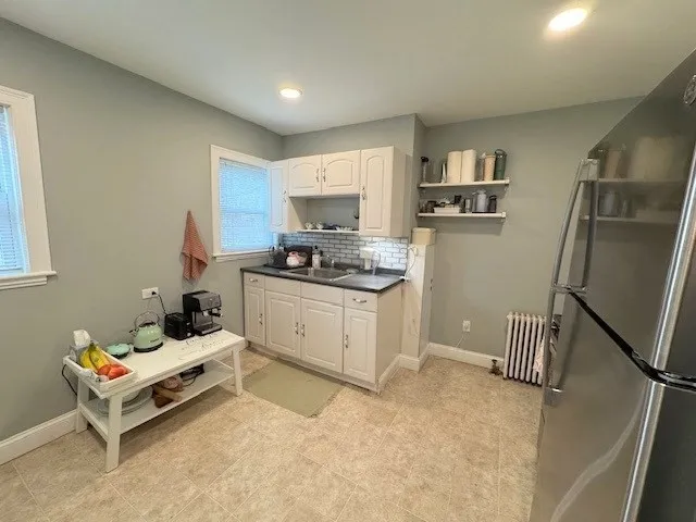 a kitchen with a refrigerator and a stove top oven