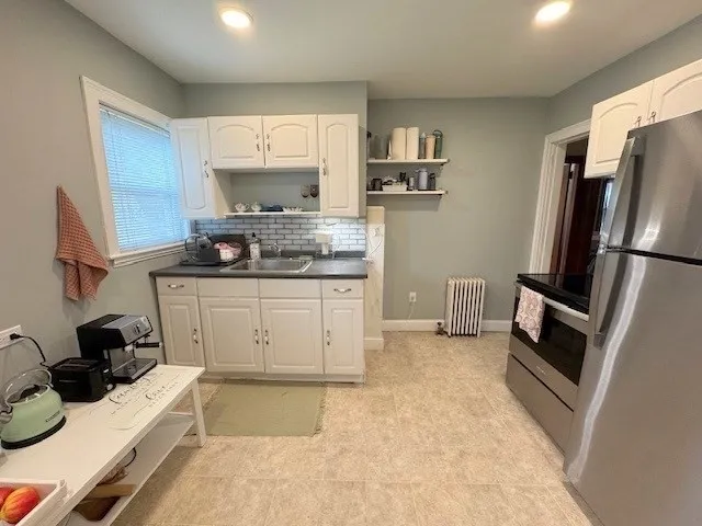 a kitchen with a sink appliances and cabinets