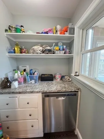 a kitchen with granite countertop lots of different kinds of food