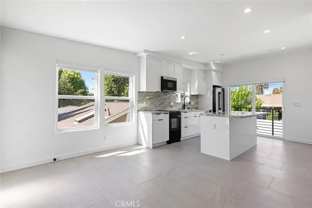 a kitchen with furniture and window