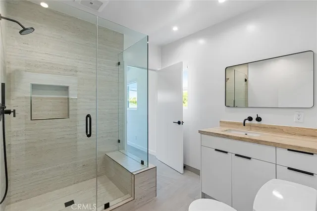 a bathroom with a sink toilet and shower