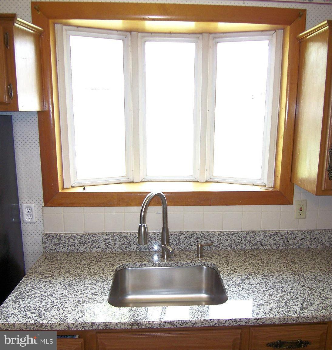 1505 Cavel Road Rosedale, MD 21237 - Photo 11 of 27 a bathroom with a granite countertop sink and a mirror