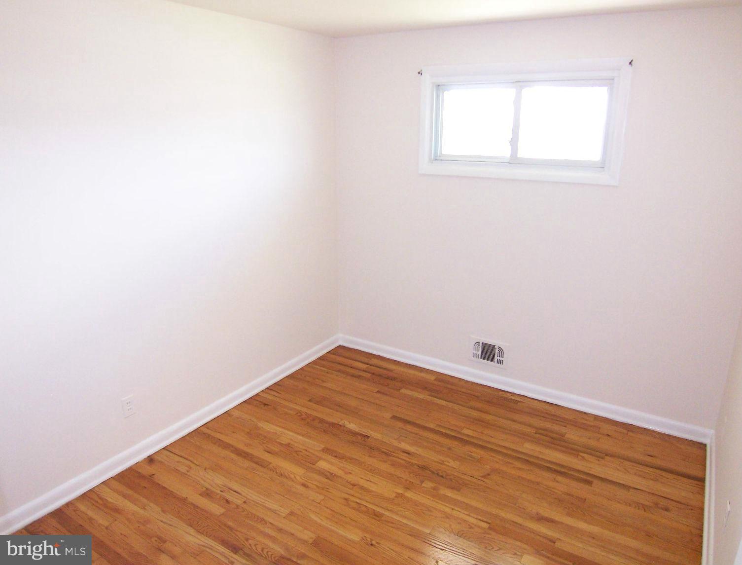 1505 Cavel Road Rosedale, MD 21237 - Photo 14 of 27 a view of a room with wooden floor and white walls
