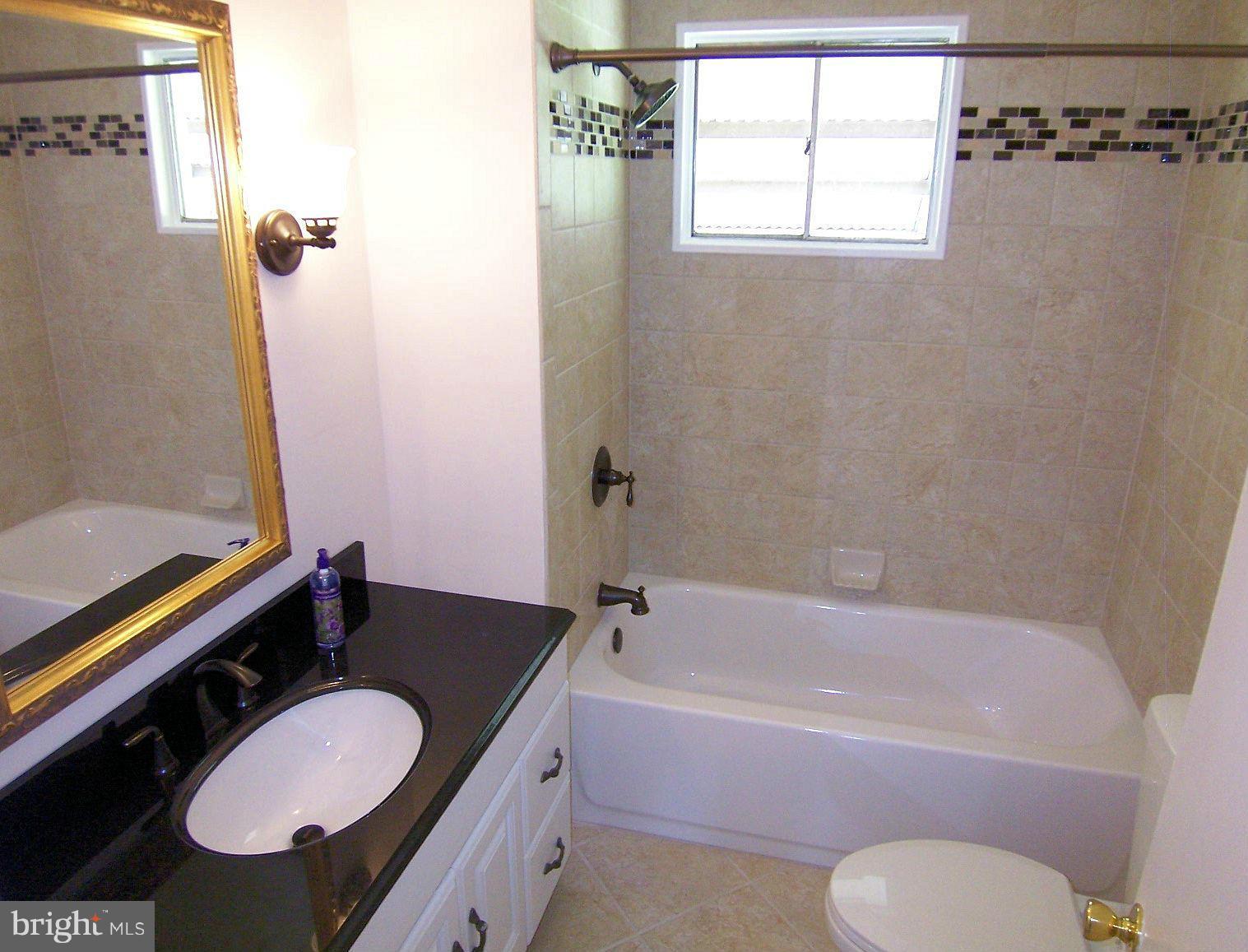 1505 Cavel Road Rosedale, MD 21237 - Photo 18 of 27 a bathroom with a sink a toilet and tub