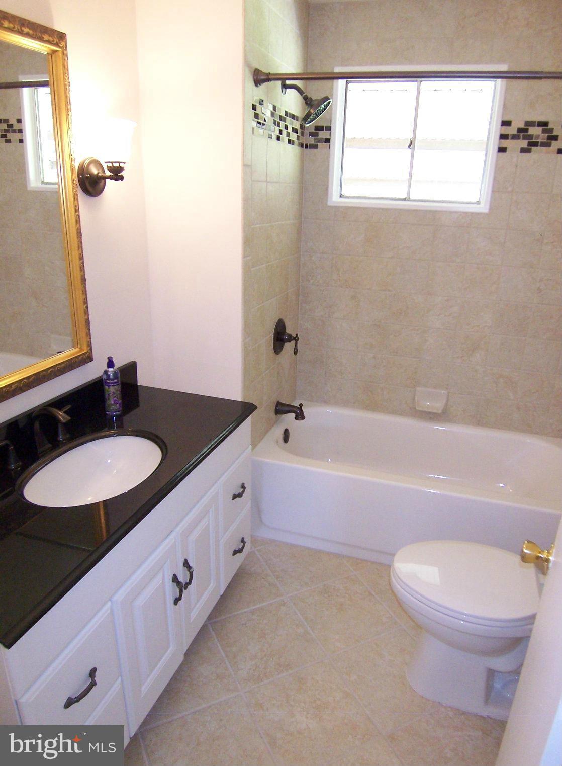1505 Cavel Road Rosedale, MD 21237 - Photo 19 of 27 a bathroom with a granite countertop sink and a mirror