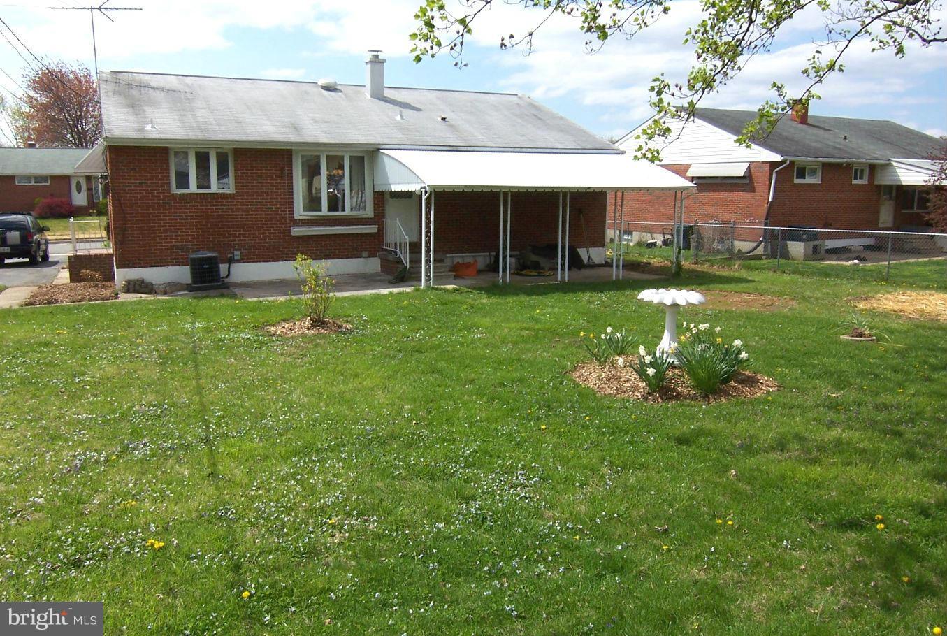 1505 Cavel Road Rosedale, MD 21237 - Photo 26 of 27 a front view of a house with a garden