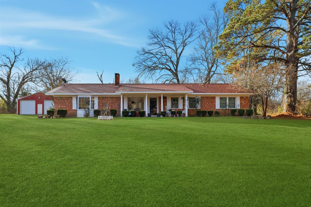 a front view of a building with a garden