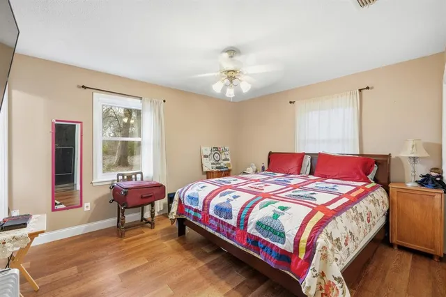 a bedroom with a bed and a window