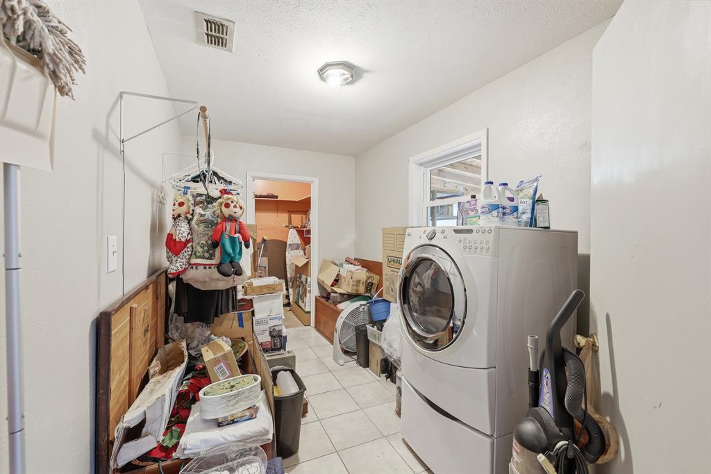240 Fm 3421 Daingerfield, TX 75638 - Photo 18 of 27 a utility room with dryer washer and a view of living room