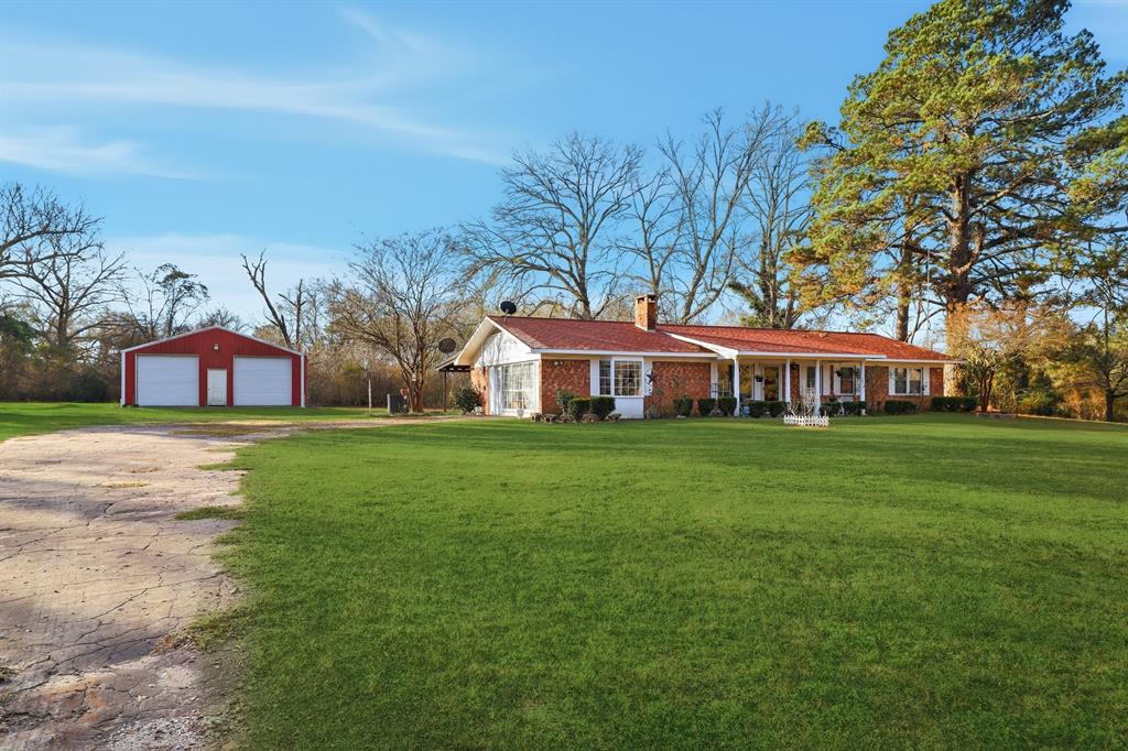 240 Fm 3421 Daingerfield, TX 75638 - Photo 2 of 27 a front view of a house with garden