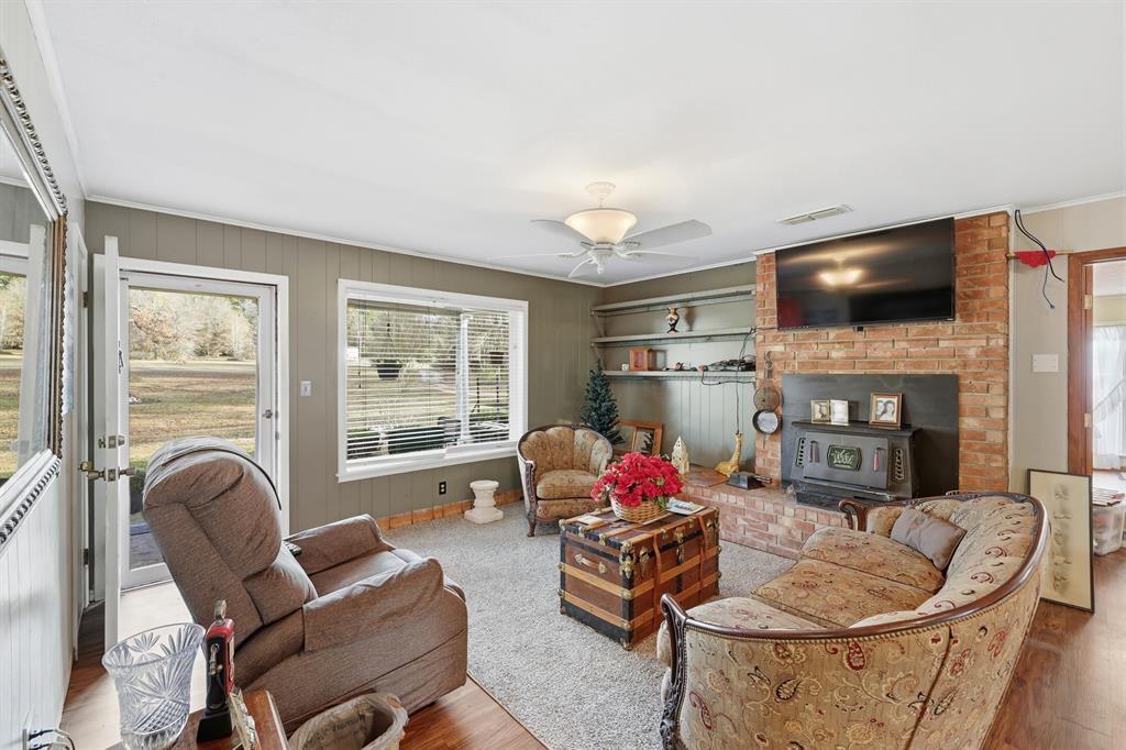 240 Fm 3421 Daingerfield, TX 75638 - Photo 4 of 27 a living room with fireplace furniture and a flat screen tv