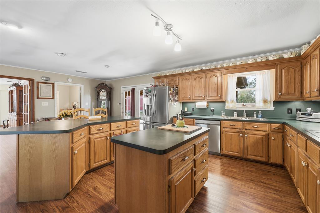 240 Fm 3421 Daingerfield, TX 75638 - Photo 7 of 27 a kitchen with stainless steel appliances granite countertop a sink stove and refrigerator