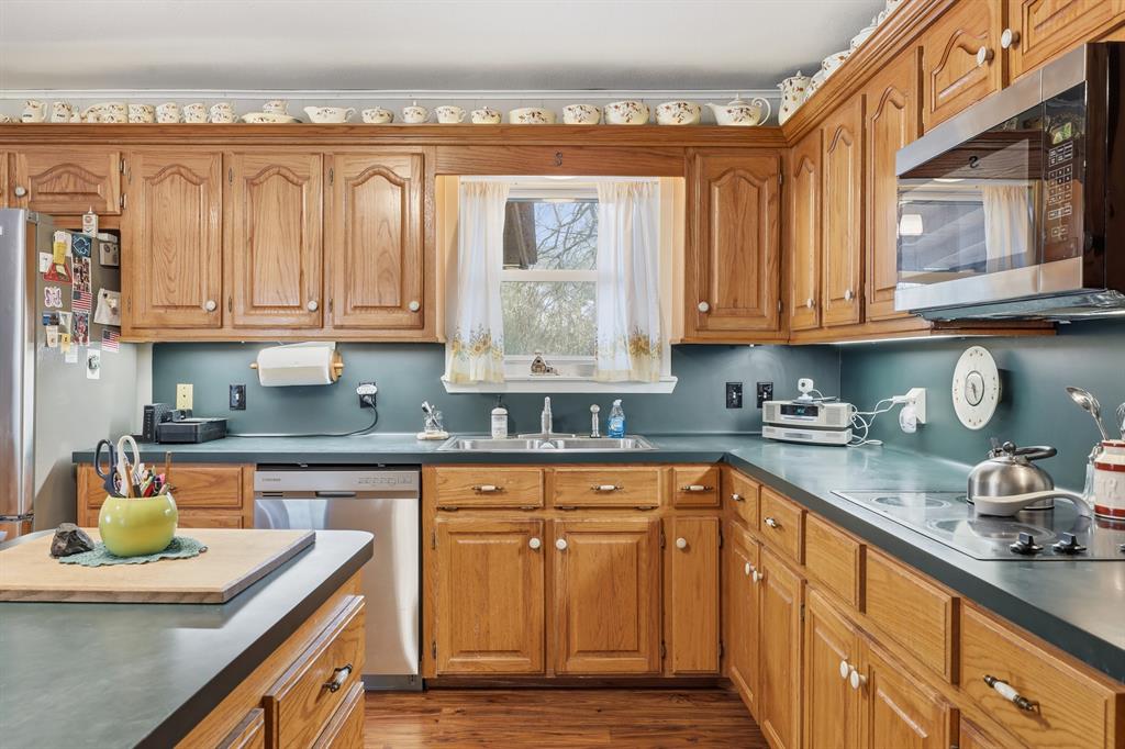 240 Fm 3421 Daingerfield, TX 75638 - Photo 8 of 27 a kitchen with stainless steel appliances granite countertop a sink a stove and cabinets