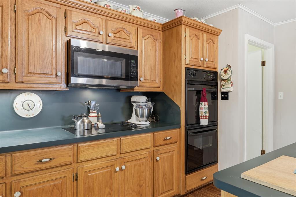 240 Fm 3421 Daingerfield, TX 75638 - Photo 9 of 27 a kitchen with stainless steel appliances granite countertop a sink a stove and cabinets