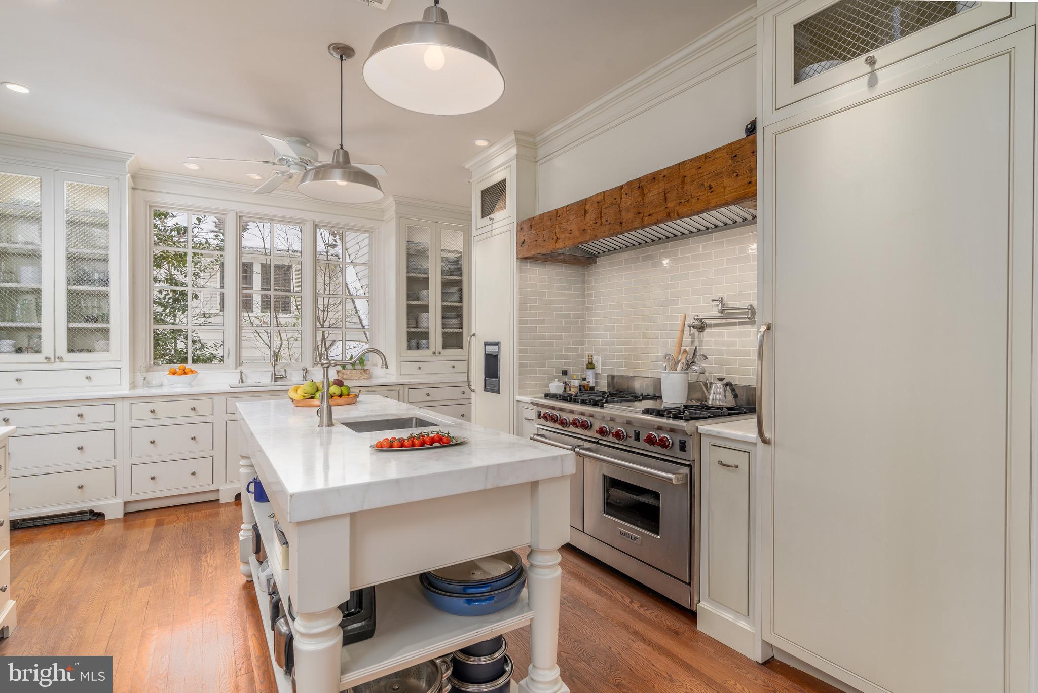 2701 36th Street Northwest Washington, DC 20007 - Photo 21 of 62 a kitchen with a stove a sink and a refrigerator