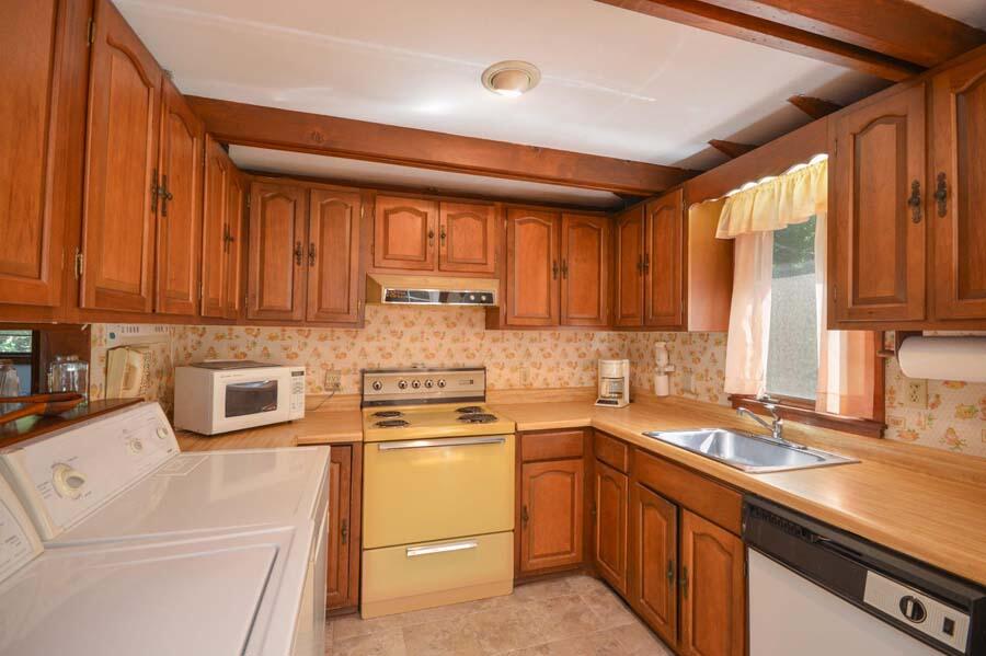 8 Treasure Lane Mashpee, MA 02649 - Photo 12 of 17 a kitchen with a sink stove top oven and cabinets