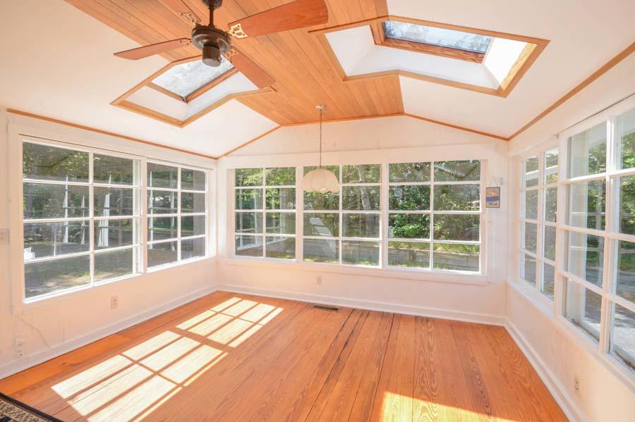 8 Treasure Lane Mashpee, MA 02649 - Photo 4 of 17 a view of empty room with windows and wooden floor