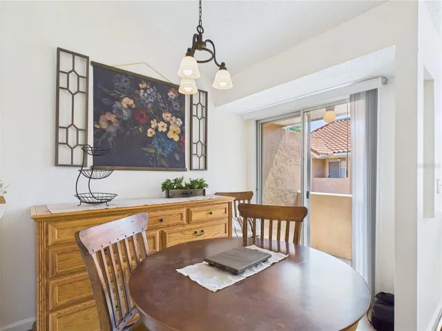 a view of a dining room with furniture wooden floor and a chandelier