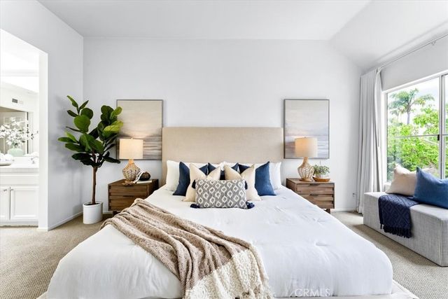 a bedroom with bed and a potted plant