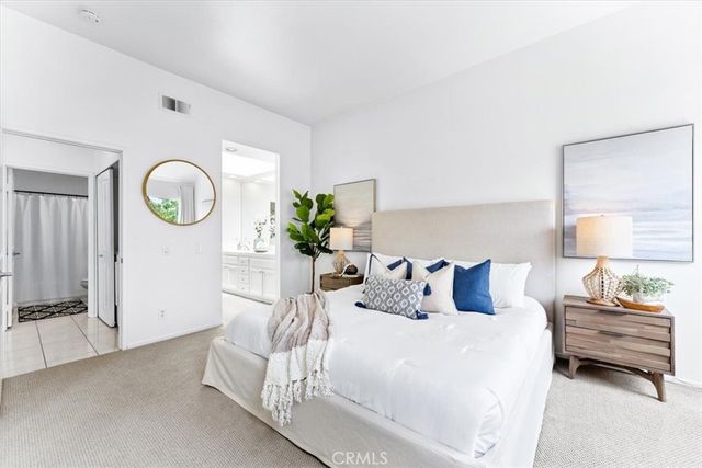 a bedroom with bed and a lamp