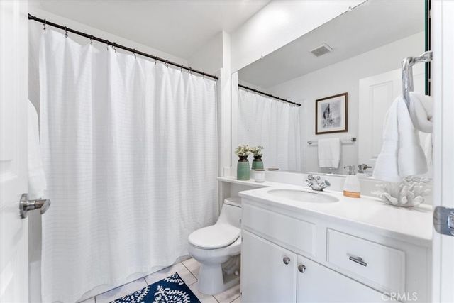 a bathroom with a sink a toilet and shower curtain