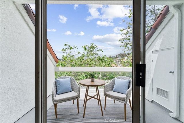 a view of a chairs and table in a balcony