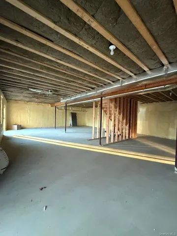 a bathroom with a granite countertop sink a toilet and a window