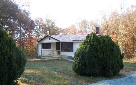 734 Industrial Park Road Blue Ridge, GA 30513 - Photo 1 of 1 a front view of a house with garden