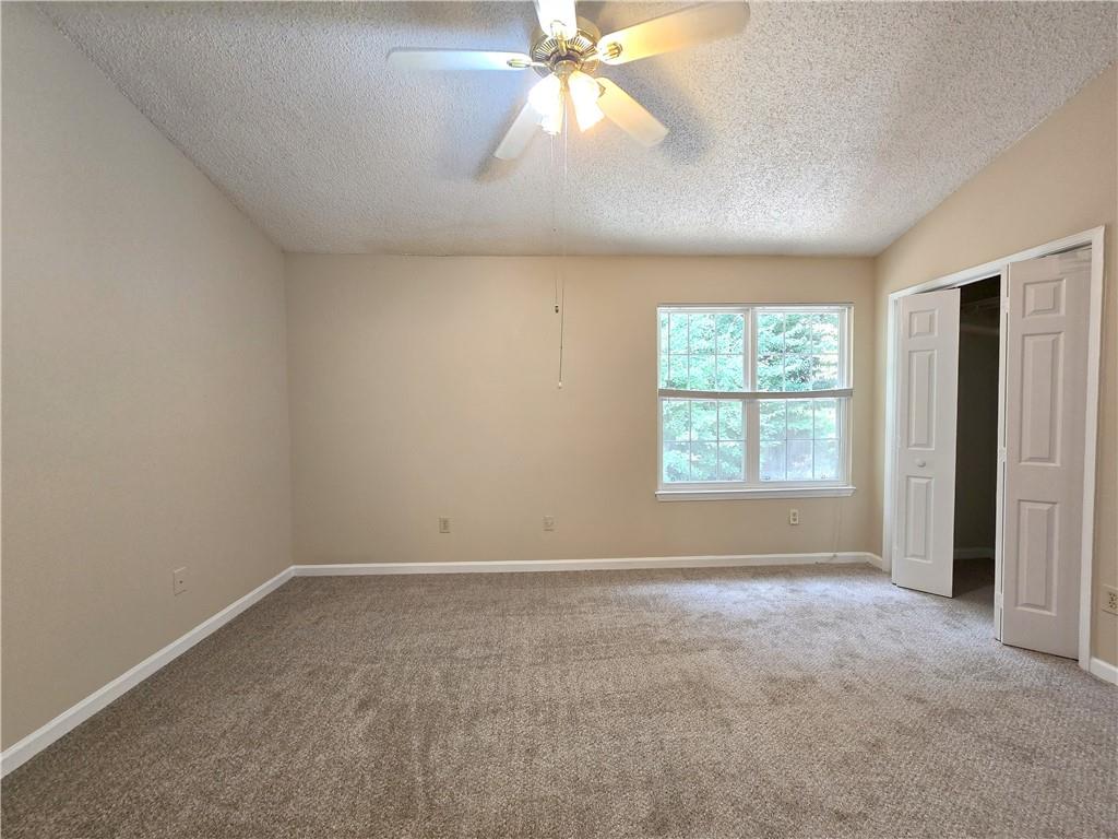 227 Quail Run Roswell, GA 30076 - Photo 11 of 20 an empty room with a window and a fan