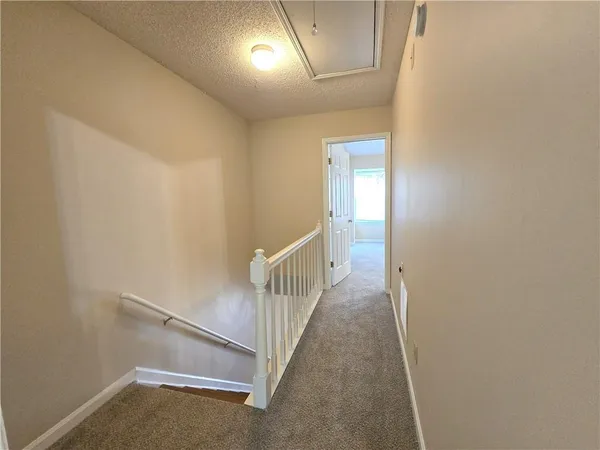 a view of a hallway with staircase