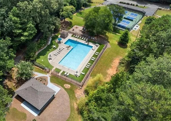 an aerial view of a house with a garden and swimming pool
