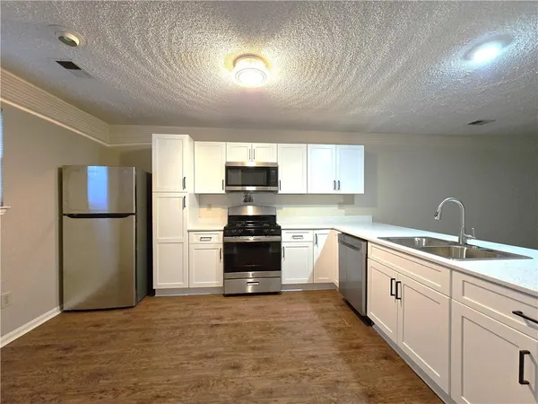 a kitchen with a refrigerator stove and microwave