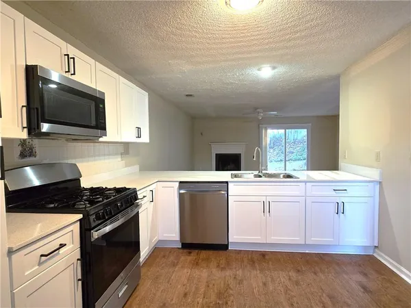 a kitchen with a stove top oven sink and cabinets