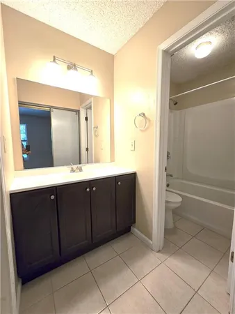 a spacious bathroom with a double vanity sink toilet and a shower