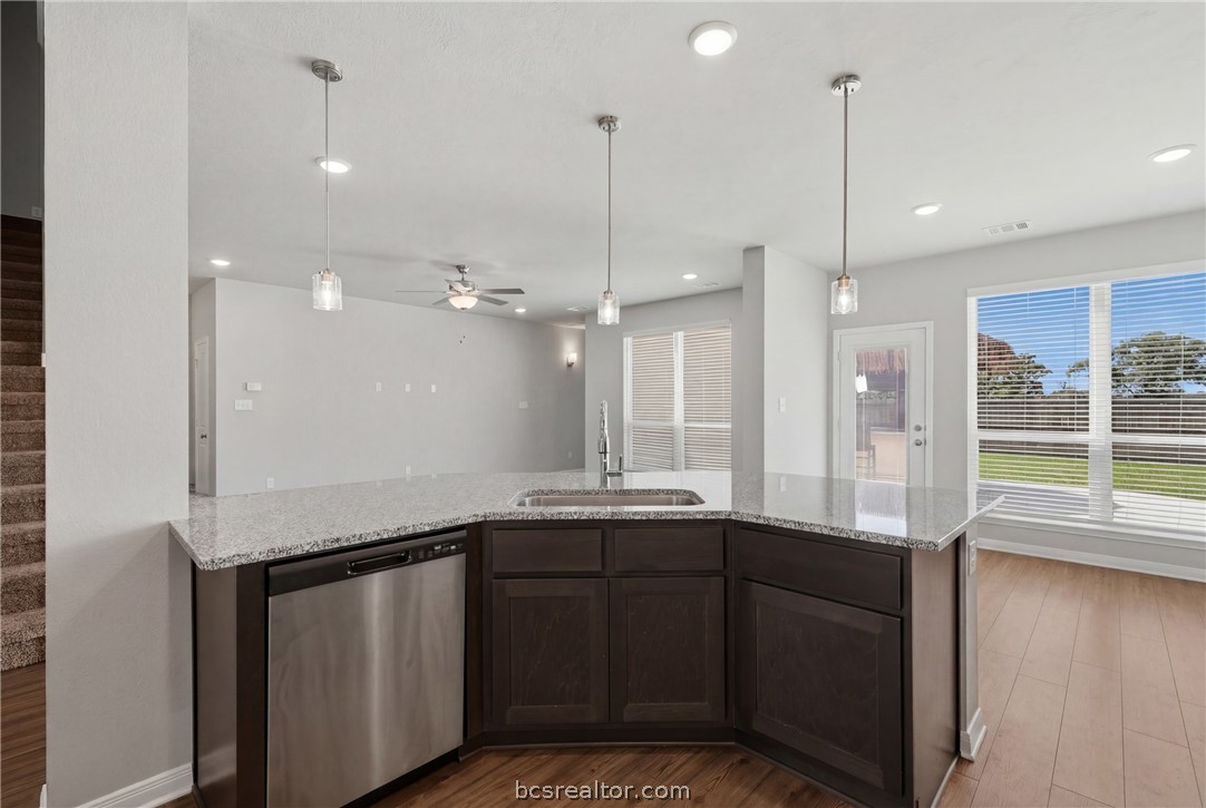 1922 Viva Road Bryan, TX 77807 - Photo 14 of 45 Open-concept kitchen featuring granite countertops, an eating bar, walk-in pantry, and seamless flow to the living room, breakfast area, and dining room.