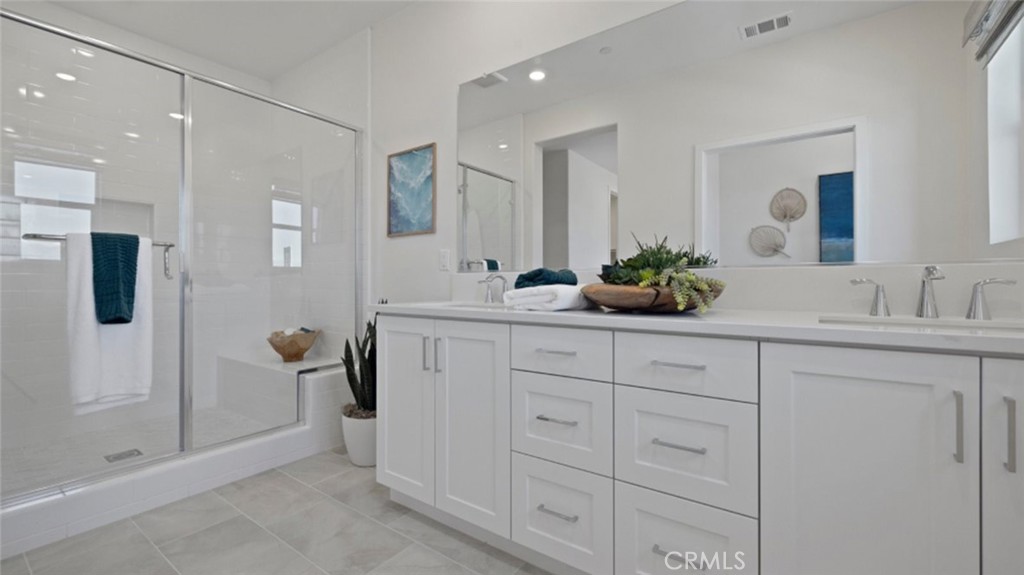 161 Scoville Irvine, CA 92618 - Photo 11 of 34 a bathroom with a double vanity sink mirror and shower