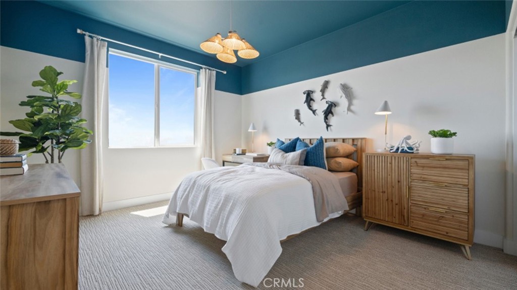 161 Scoville Irvine, CA 92618 - Photo 17 of 34 a spacious bedroom with a bed and a chandelier