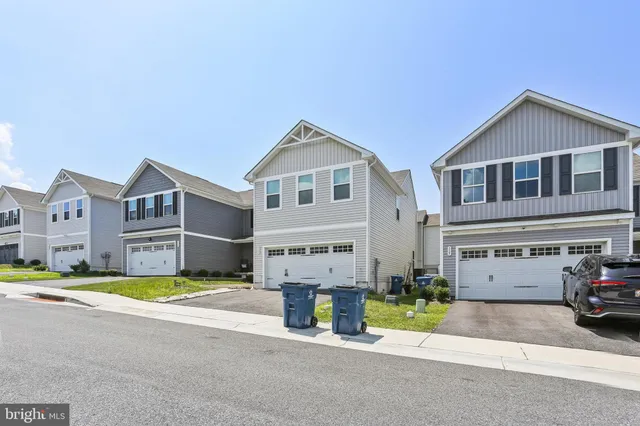 a view of building with cars parked in front of it