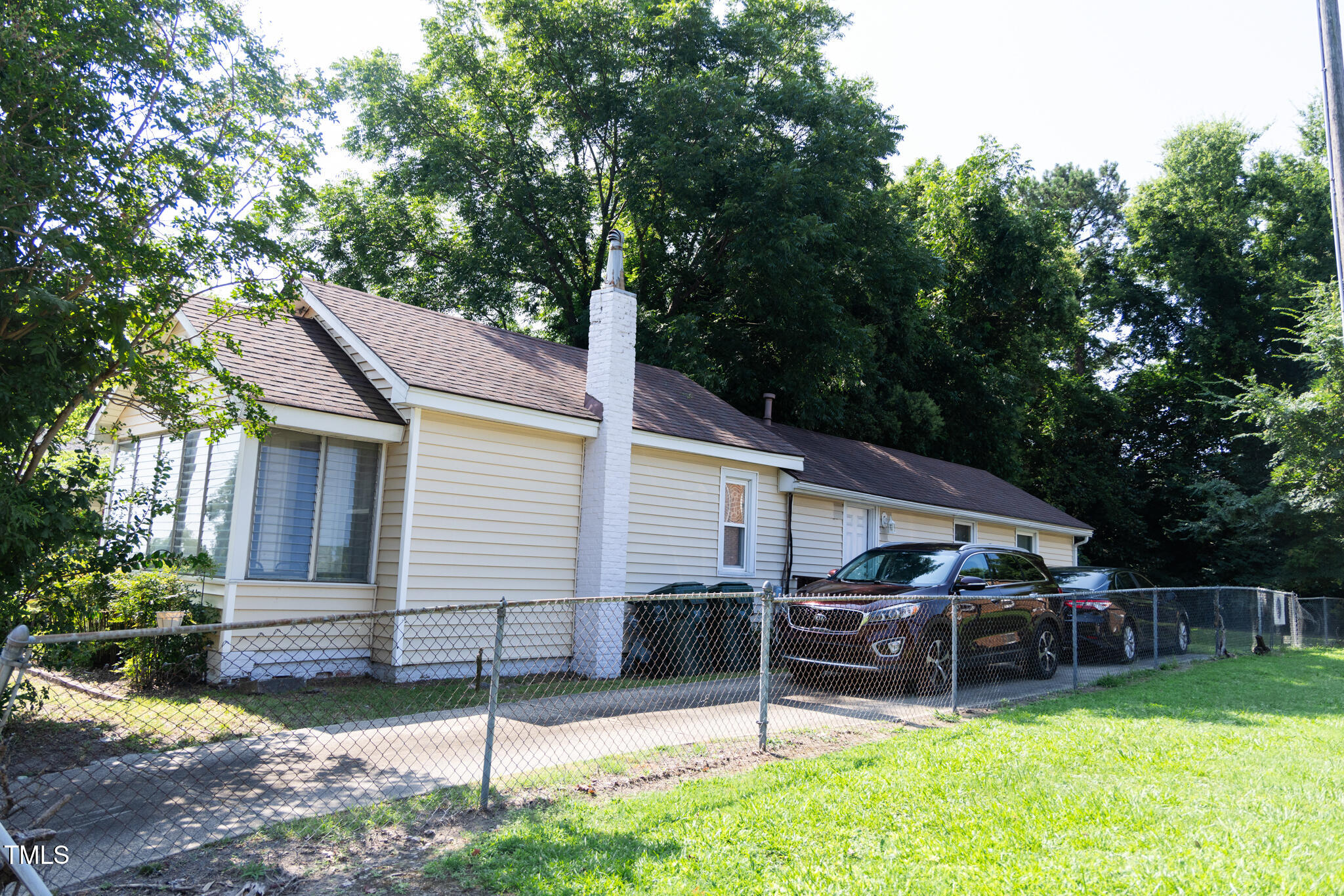 1320 Oakwood Avenue Raleigh, NC 27610 - Photo 3 of 6 a view of a house with a backyard and a large tree