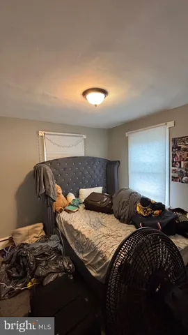 a bedroom with a bed and a night stand