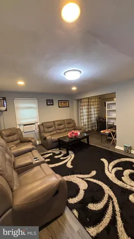 a gym room with furniture a rug and a window