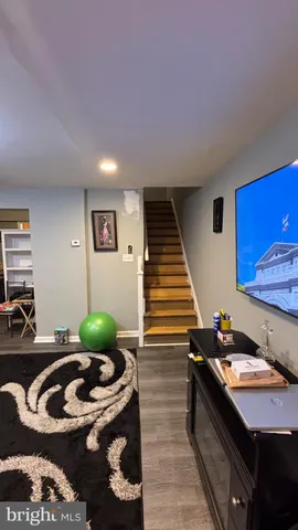 a living room with furniture and flat screen tv