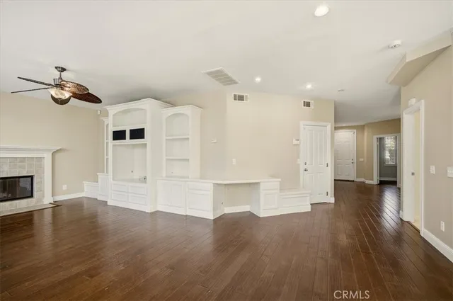 a view of a kitchen with wooden floor and a ceiling fan
