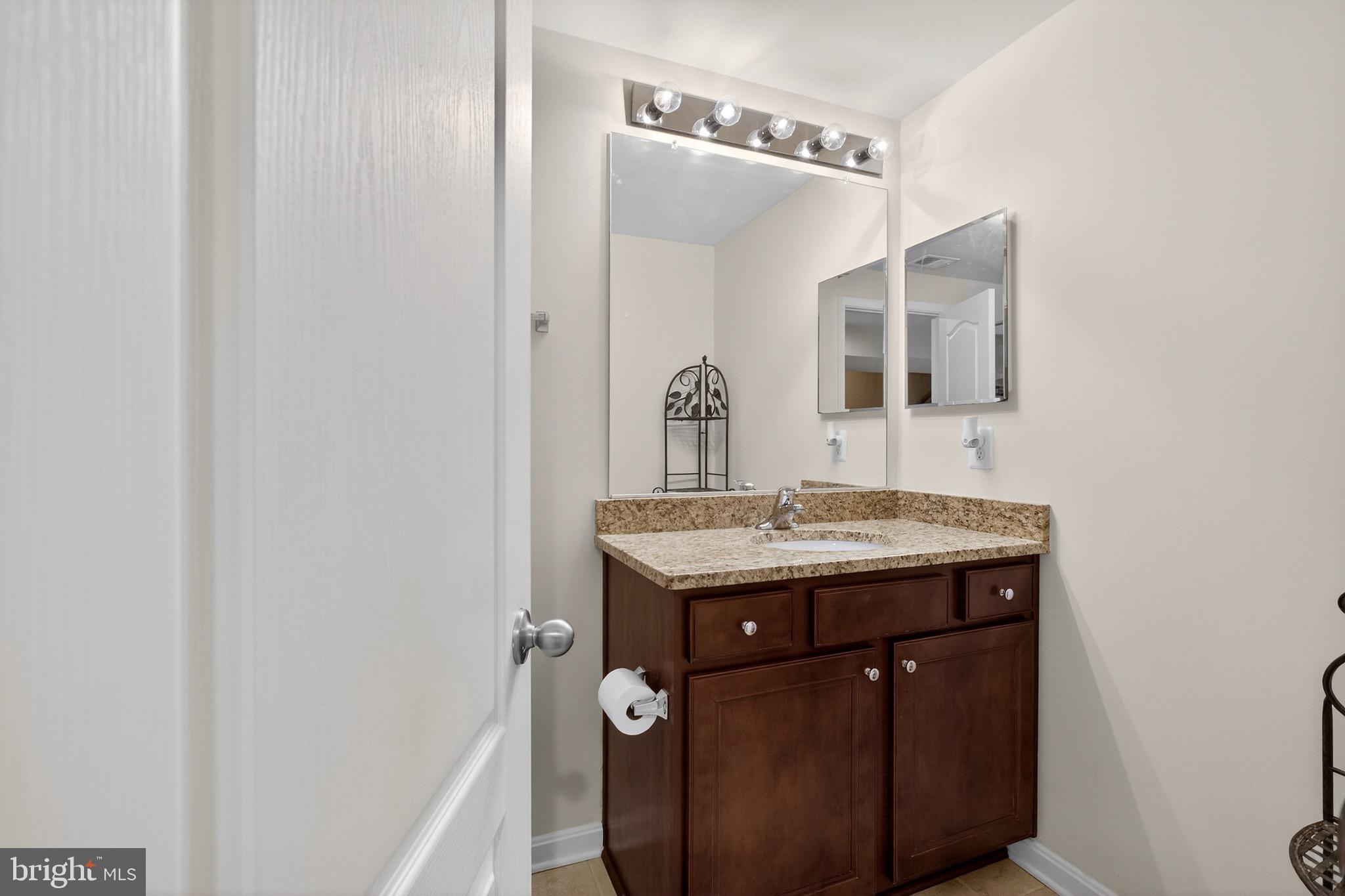 30045 Stage Coach Circle Milford, DE 19963 - Photo 56 of 72 a bathroom with a granite countertop sink a mirror and a toilet