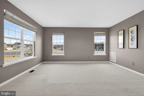 a living room with fireplace furniture and a wooden floor