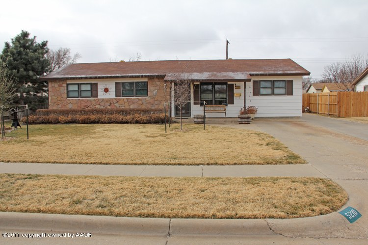 5210 South Travis Street Amarillo, TX 79110 - Photo 1 of 29 front view of a house with a yard