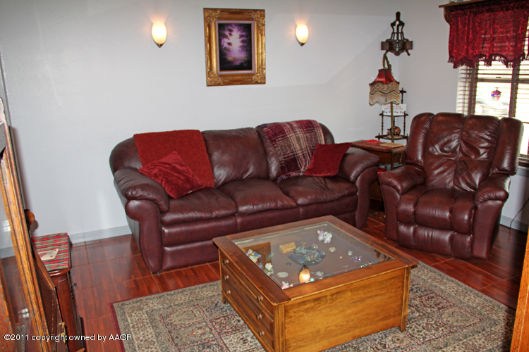 5210 South Travis Street Amarillo, TX 79110 - Photo 3 of 29 a living room with furniture a couch and two windows
