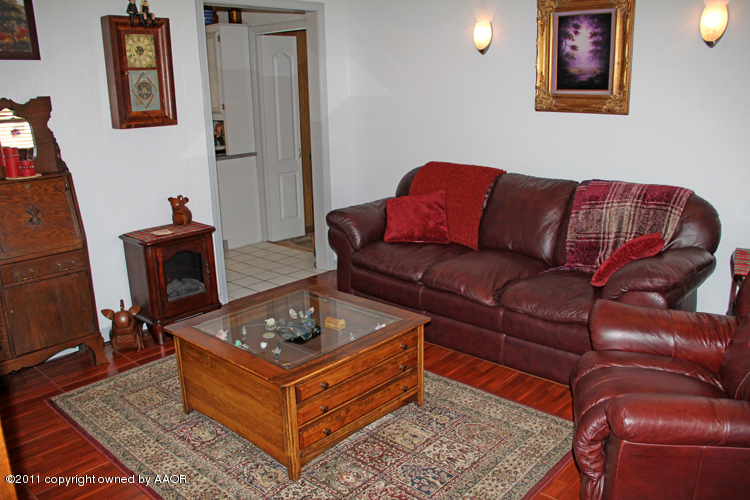 5210 South Travis Street Amarillo, TX 79110 - Photo 4 of 29 a living room with furniture and a wooden floor