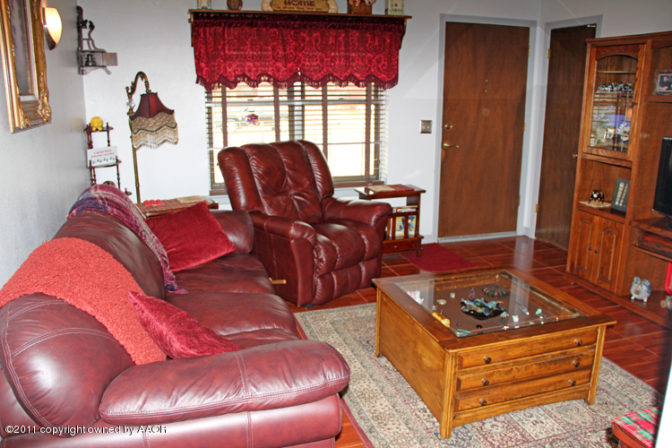 5210 South Travis Street Amarillo, TX 79110 - Photo 5 of 29 a living room with furniture and a fireplace